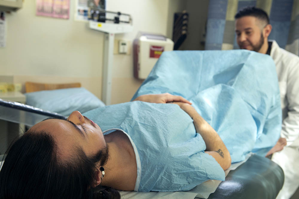 Two people in a health care exam. Image under creative commons from Broadly
