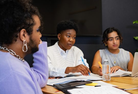 A group of co-workers of varying genders having a meeting