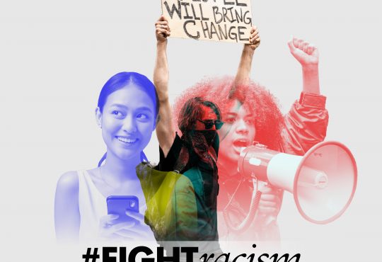 Image of three people. One speaking into a megaphone and one holding a sign that says we the people will bring change. The hashtag #FightRacism is below the image.